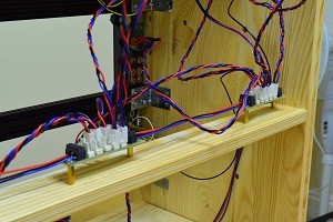 View of two small PCBs with connectors, with a bunch of cables connected to them